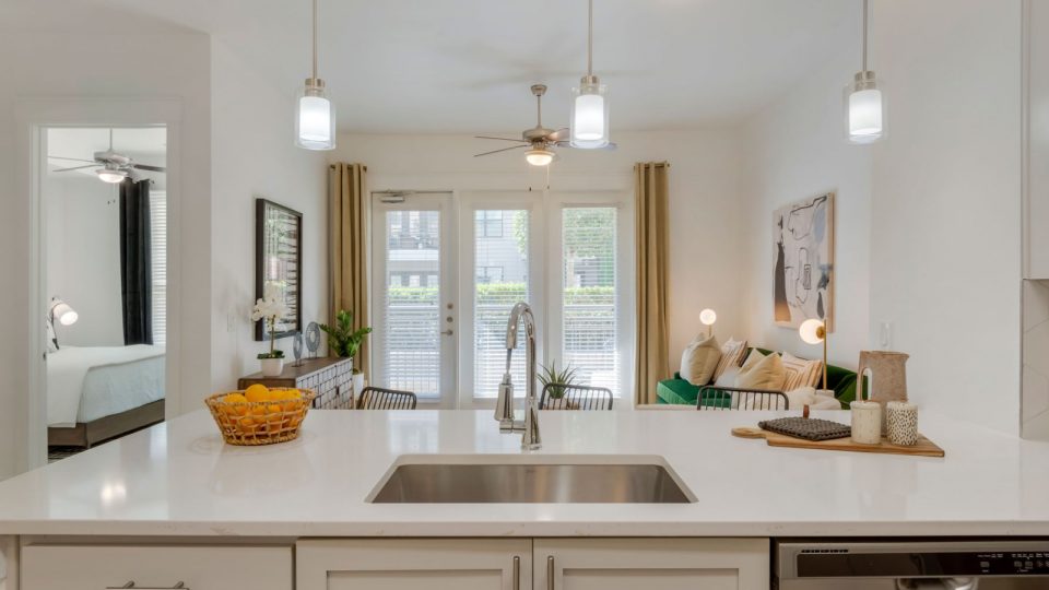 a kitchen with white cabinets and a sink at The Allure