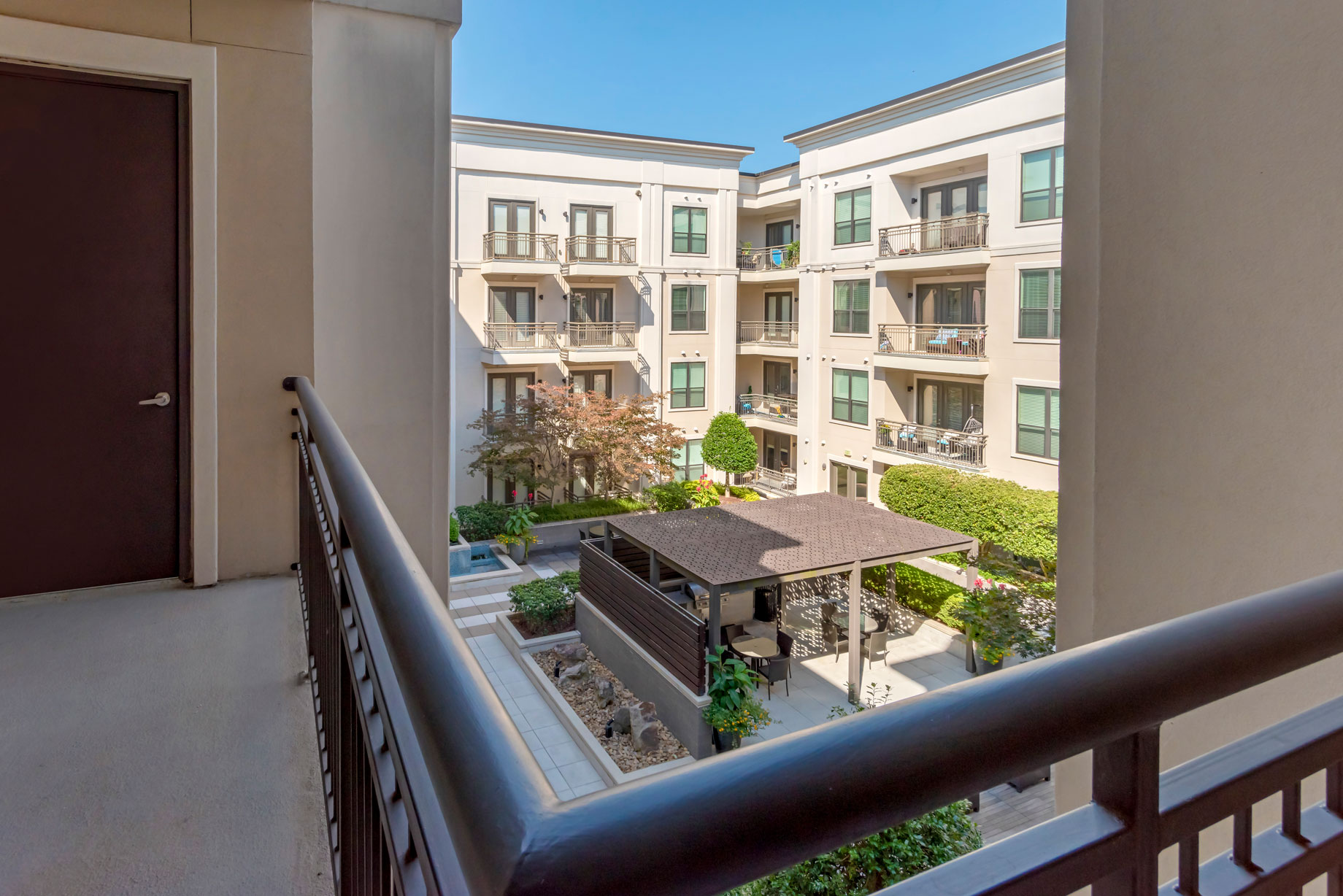 balcony view of apartment complex with patio furniture at The Allure