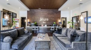 the lobby of a modern apartment building with couches and chairs at The Allure